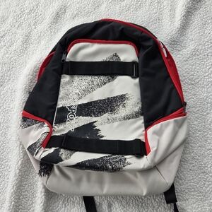 Jansport ANTICS Stylish Red and Black Backpack skateboard storage straps,